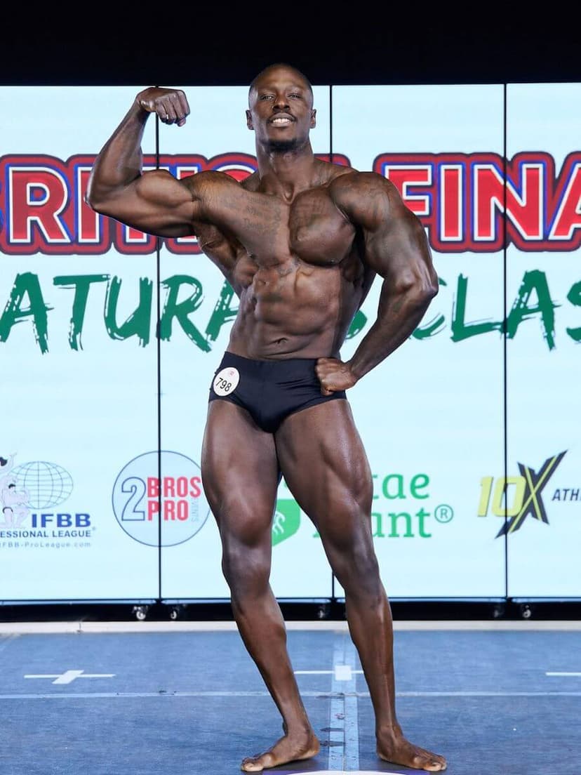 An image of Joel, posing at his bodybuilding competition